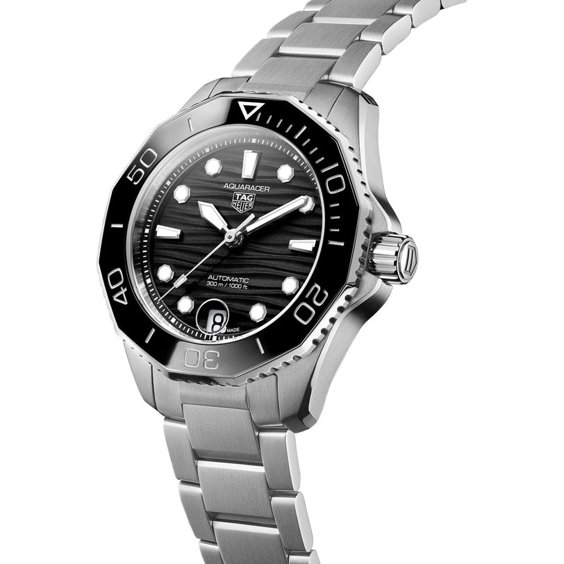 The TAG Heuer Aquaracer Professional 300 Date dive watch, featuring a stainless steel case, black bezel and dial, luminous markers, and metal bracelet, is displayed at an angle on a white background.