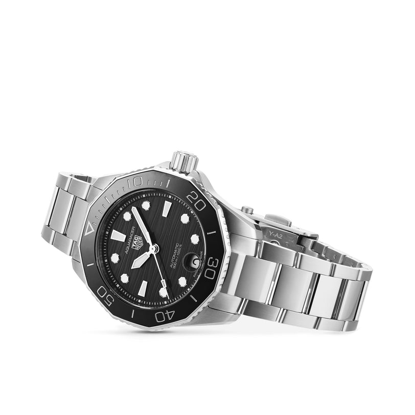 The TAG Heuer Aquaracer Professional 300 Date dive watch, featuring a stainless steel case, black bezel and dial, silver hour markers, and a metal link bracelet, is shown against a white background.