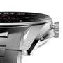 Close-up of the TAG Heuer Connected Calibre E4 smartwatch in silver with a black bezel, textured crown, and part of its metal bracelet visible.