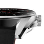 Close-up side view of the avant-garde design of the TAG Heuer Connected Calibre E4, featuring a polished metal casing, textured crown, and black leather strap.