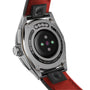 Close-up of the back of the TAG Heuer Connected Calibre E4 smartwatch, showcasing its detailed engravings, advanced sensors, and bold red leather strap.