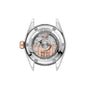 Back view of the TAG Heuer Carrera Date watch case displaying its automatic movement, engraved details, visible gears, and a rose gold rotor.