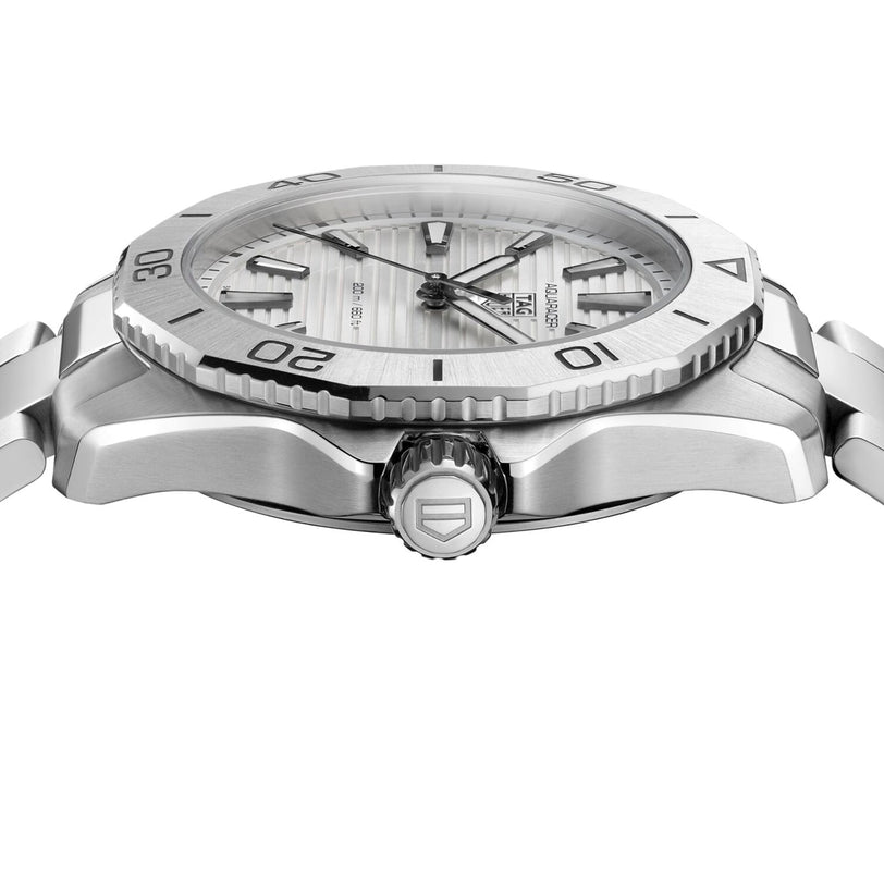 Side view of the TAG Heuer Aquaracer Professional 200, featuring a ridged bezel, white textured dial, stainless steel case, and metal bracelet, showcasing detailed crown and case design.
