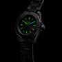 The TAG Heuer Aquaracer Professional 200 is a black sports watch with a stainless steel case, metal band, and luminous green hour markers and hands, shown against a black background.