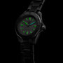 A TAG Heuer Aquaracer Professional 200 sports watch with a black stainless steel case and glowing green hour markers and hands is displayed against a dark background.