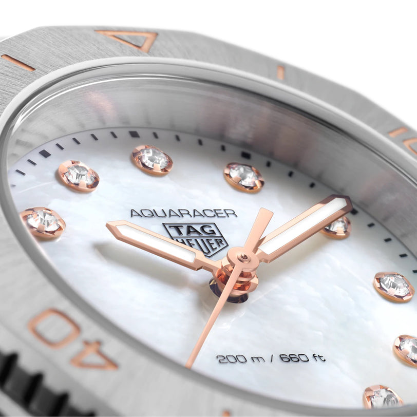Close-up of the TAG Heuer Aquaracer Professional 200 watch face with a mother-of-pearl dial, diamond hour markers, rose gold hands, stainless steel case, and 200m/660ft water resistance.
