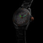 A TAG Heuer Aquaracer Professional 200 wristwatch with a stainless steel case, black metal band, dark dial with orange accents, and luminous hands is photographed against a black background.