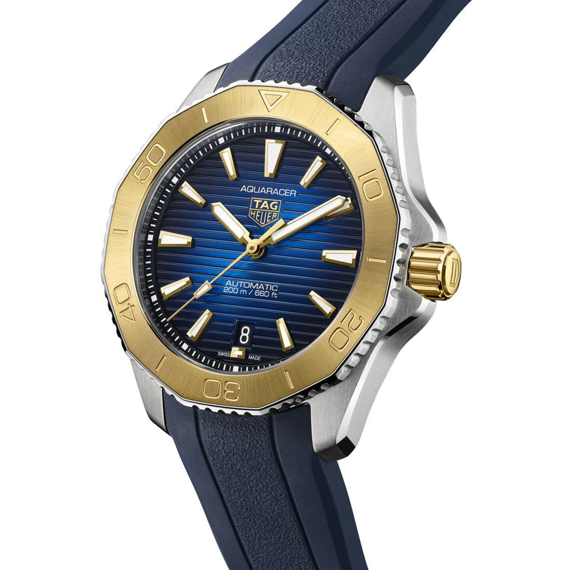 The TAG Heuer Aquaracer Professional 200 Date features a blue dial, gold bezel, gold crown, blue strap, and luminous markers and hands.