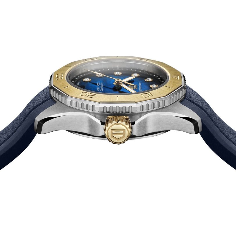 A close-up side view of the TAG Heuer Aquaracer Professional 200 Date, featuring a blue strap, a silver and gold bezel, and a crown with an engraved logo.