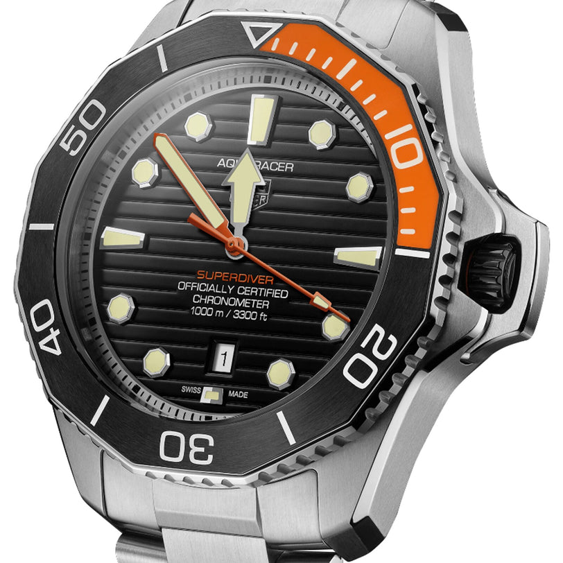 Close-up of a TAG Heuer Aquaracer Professional 1000 Superdiver watch with black and orange bezel, black dial, stainless steel case and bracelet, water resistance, and date display at 6 o’clock.