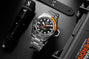 The TAG Heuer Aquaracer Professional 1000 Superdiver, featuring a stainless steel case and a black and orange bezel, is shown beside scuba gear and a flashlight, emphasizing its outstanding water resistance.
