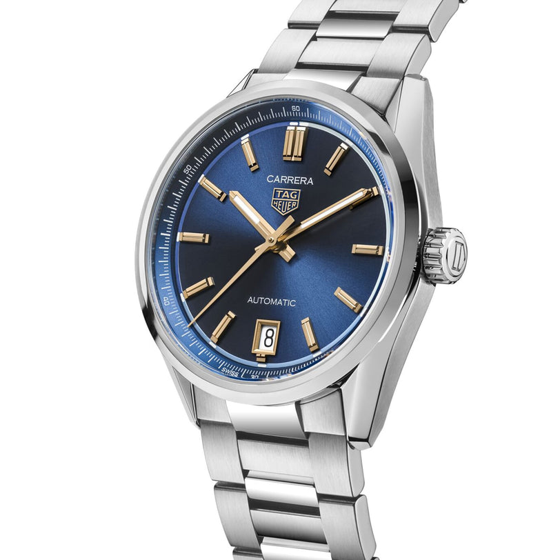 The TAG Heuer Carrera Date wristwatch features a blue dial, gold hour markers, and a date window at 6 o’clock. With its stainless steel case and sleek design, the Carrera Date is a striking statement of endurance and elegance.