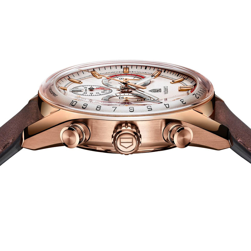 A close-up side view of the TAG Heuer Special Edition Carrera Chronosprint x Porsche watch in rose gold with a white dial, two pushers, automatic chronograph movement, and a brown leather strap showcasing intricate face details.