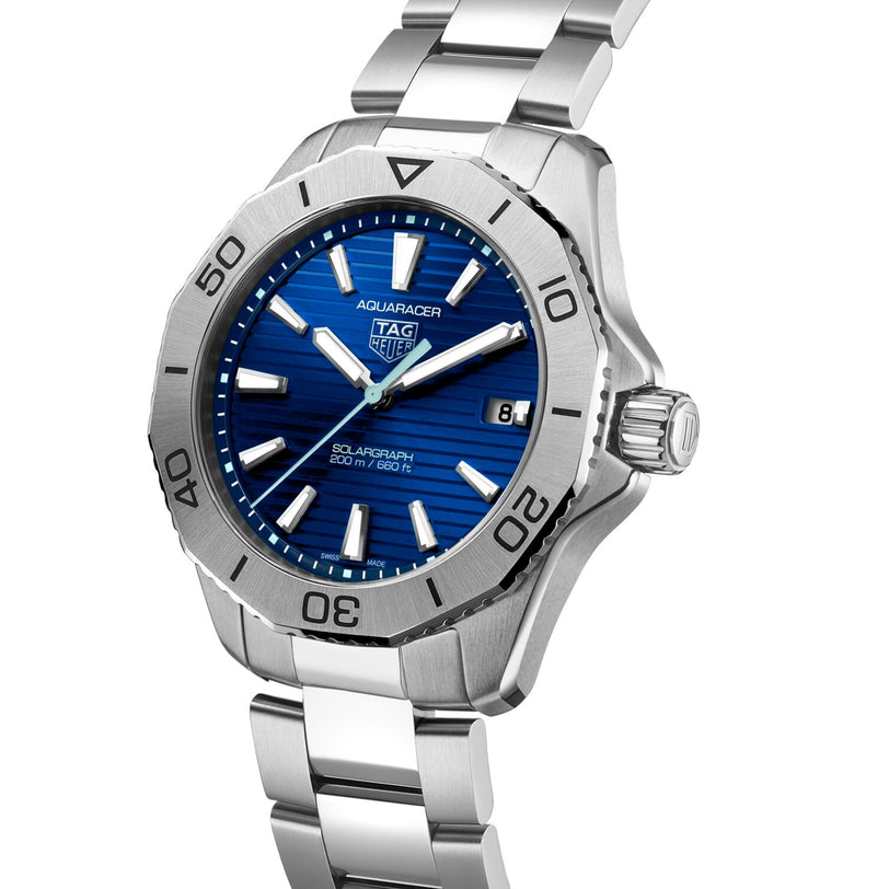 The TAG Heuer Aquaracer 200 Professional Solargraph, a silver solar-powered watch with a blue dial, date display, and stainless steel bracelet, is shown against a white background.
