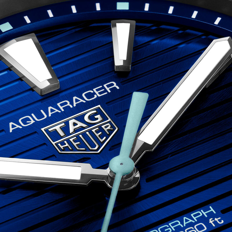 Close-up of the TAG Heuer Aquaracer 200 Professional Solargraph watch face with luminous hands and markers on a blue textured dial, highlighting its advanced solar-powered technology.