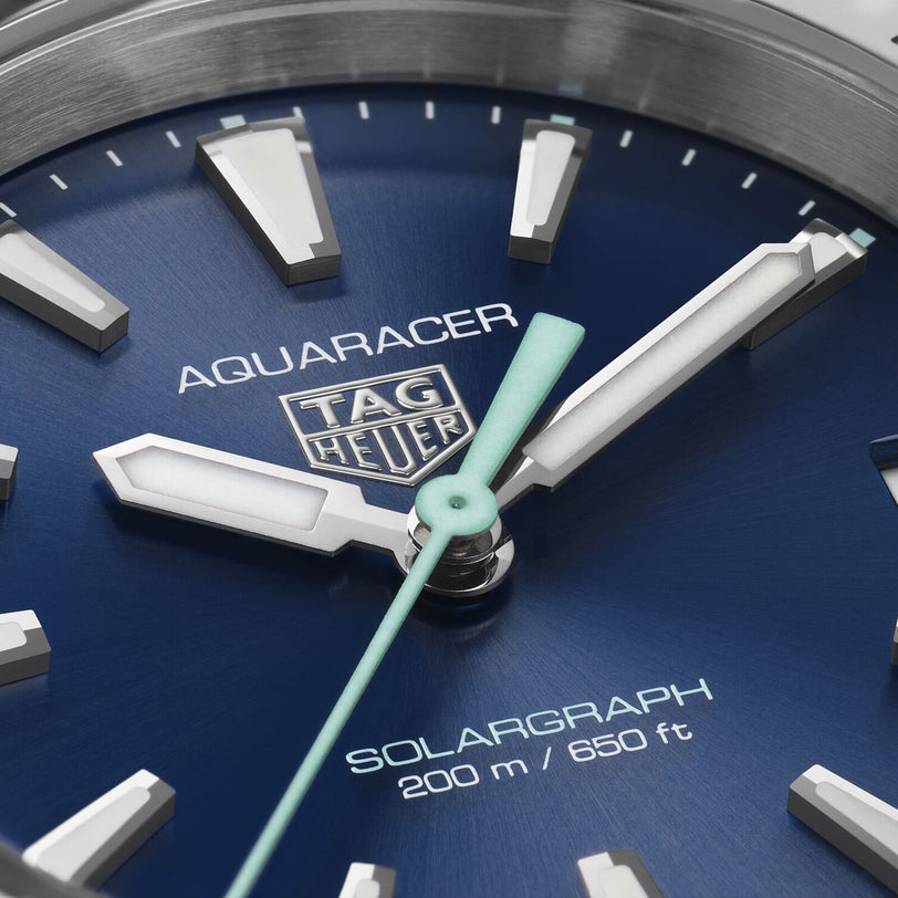 Close-up of a TAG Heuer Aquaracer 200 Professional Solargraph watch face, showing the brand logo, luminescent hands, and 200-meter water resistance.