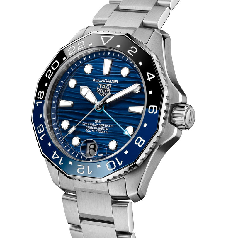 The TAG Heuer Aquaracer Professional 300 GMT, featuring a stainless steel case, blue and black bezel, blue dial, and silver bracelet, is displayed on a white background—a striking luxury chronograph.