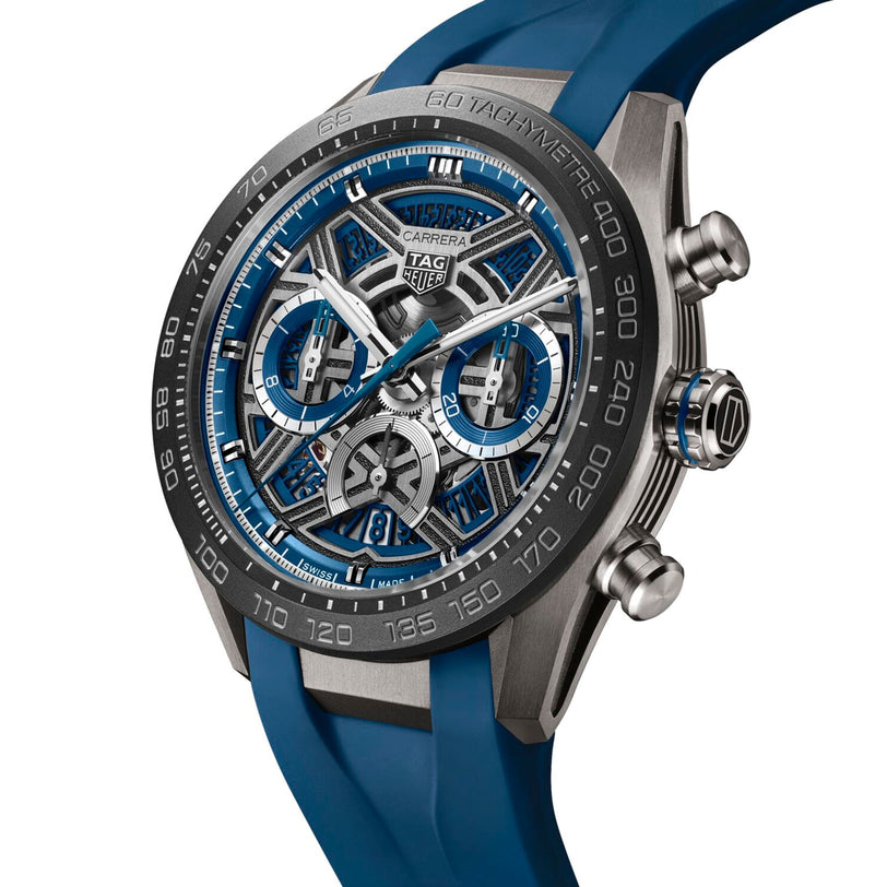 A close-up of a TAG Heuer Carrera Chronograph Extreme Sport watch with a blue rubber strap, skeleton dial, chronograph subdials, TH20-00 movement, and a tachymeter bezel.