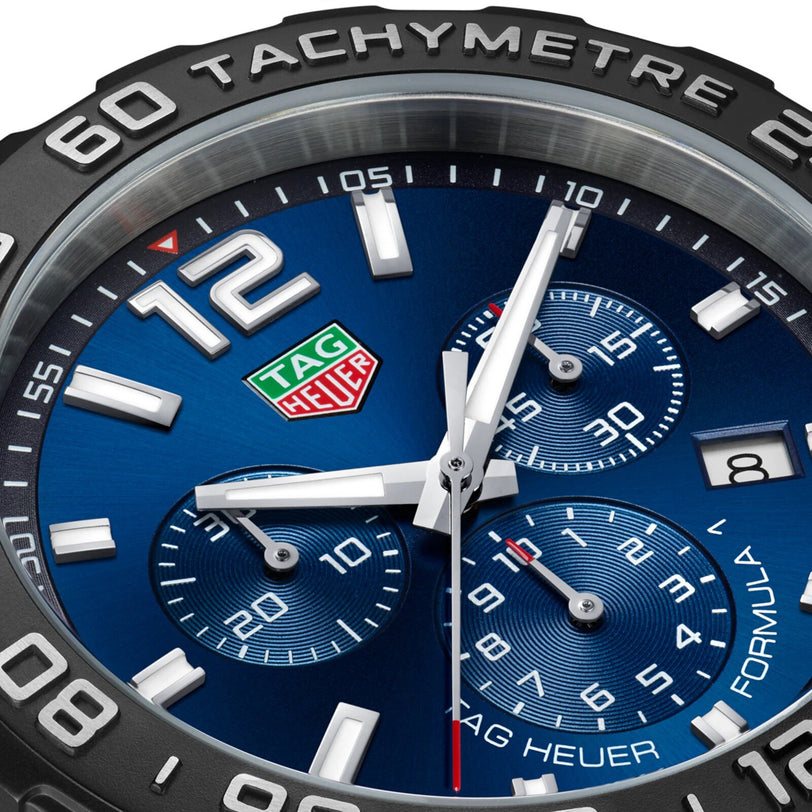 Close-up of the TAG Heuer Formula 1 Chronograph watch face featuring a blue dial, detailed subdials, date window, and a sleek tachymeter bezel.