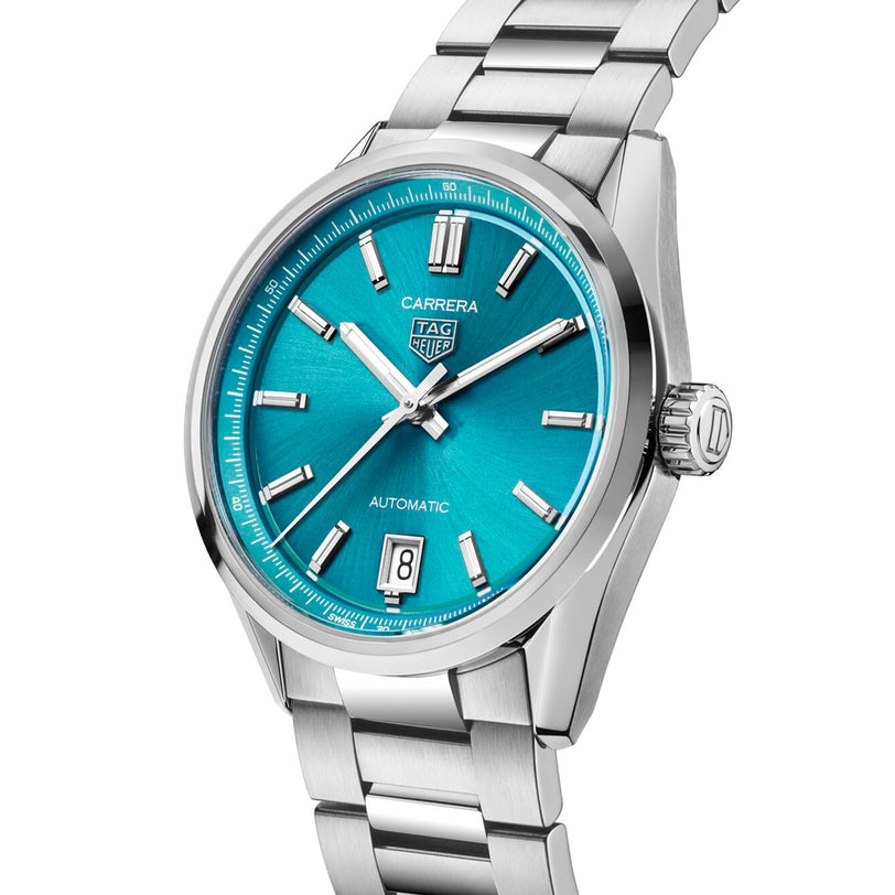 The TAG Heuer Carrera Date is a silver wristwatch with a teal blue dial, calibre 7 automatic movement, silver hour markers, date at 6 o’clock, and a stainless steel bracelet.