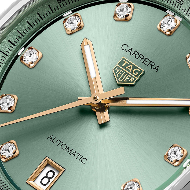 Close-up of the TAG Heuer Carrera Date, showcasing its green sunray-brushed dial with gold hands, diamond hour markers, and a date window at 6 o’clock.