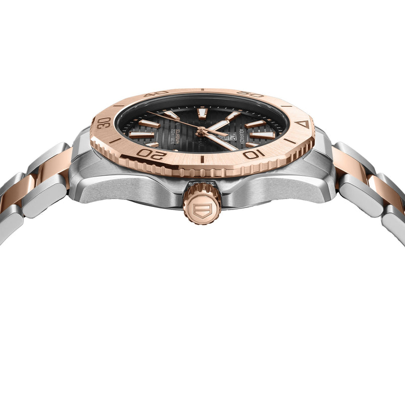 Side view of a TAG Heuer Aquaracer Professional 200 Solargraph wristwatch featuring a silver and rose gold band, black dial, and a rose gold bezel engraved with numbers.