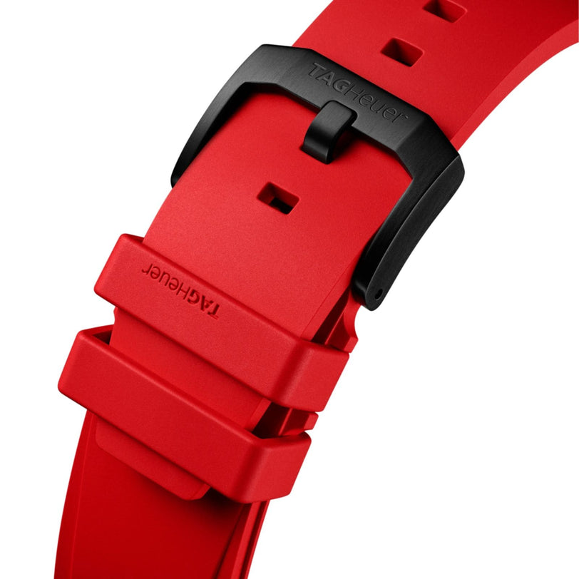 Close-up of a red rubber strap with black buckle for the TAG Heuer Formula 1 Chronograph, featuring the TAG Heuer brand engraved on both the strap and buckle.