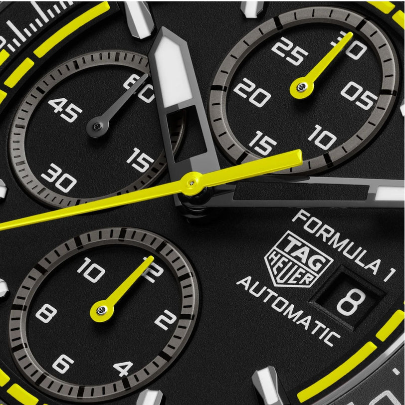Close-up of a TAG Heuer Formula 1 Chronograph watch face featuring yellow accents and three subdials.