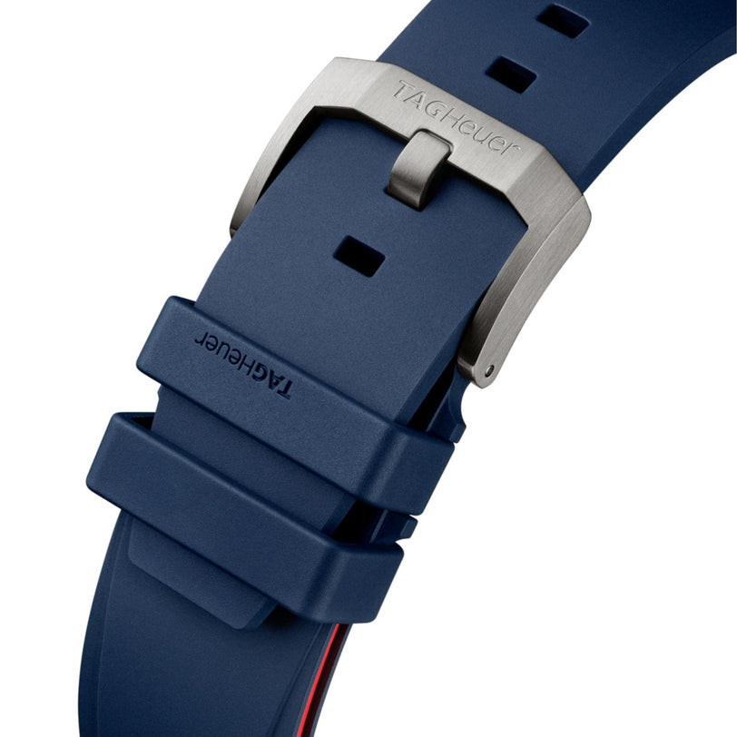 Close-up of a blue TAG Heuer Formula 1 Chronograph X Oracle Red Bull Racing rubber strap with a silver buckle engraved with the TAG Heuer logo, highlighting motorsport-inspired design details.