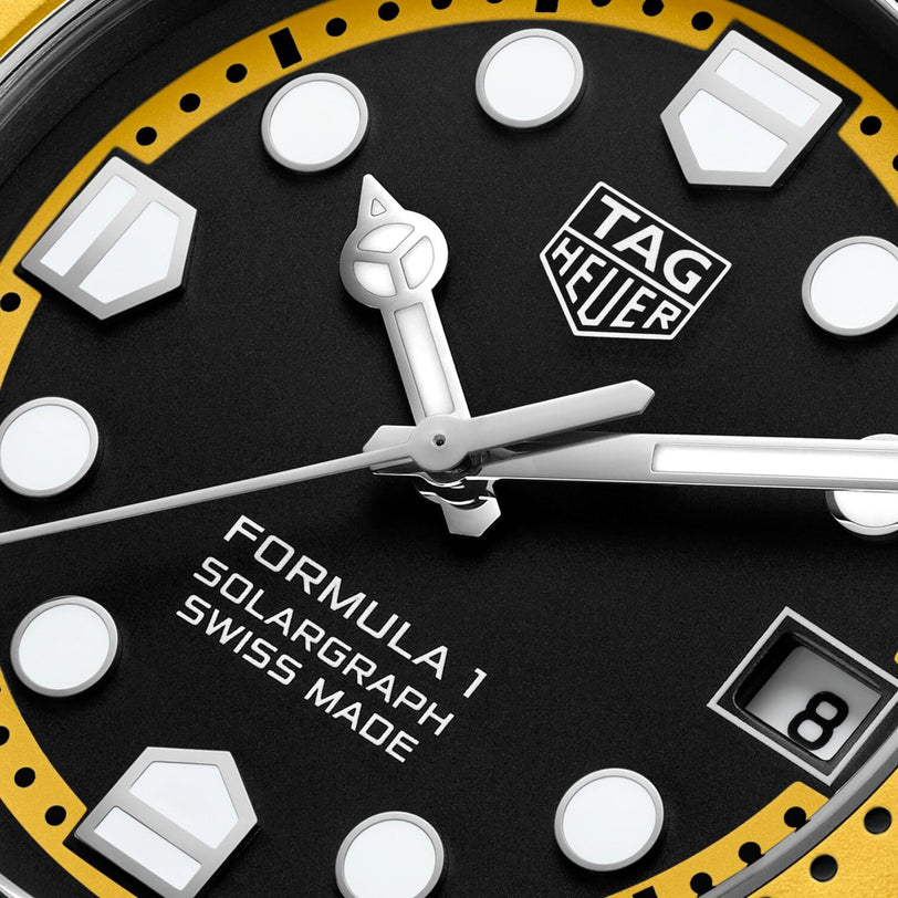 Close-up of a TAG Heuer Formula 1 Solargraph watch face featuring silver hands, a date display, and bold white markers.