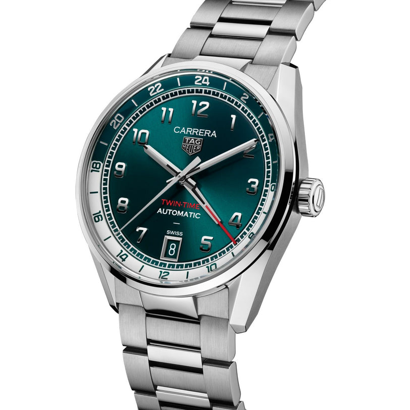 A TAG Heuer Carrera Date Twin-Time watch with a silver case, teal face, and silver bracelet, displaying the time 10:10.