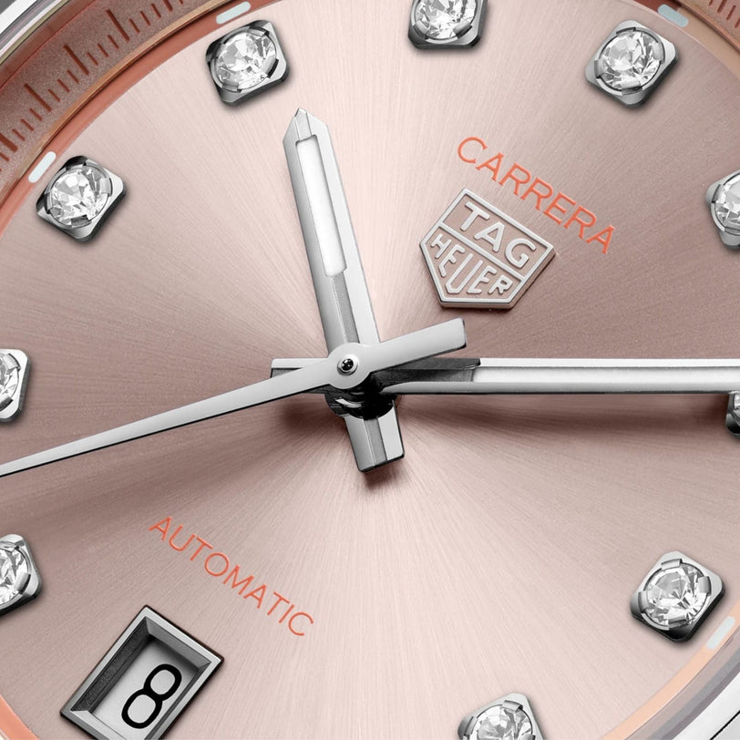 Close-up of the TAG Heuer Carrera Date watch face featuring diamond hour markers and a date window displaying the number 8.