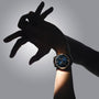 A person’s hand wearing the H. Moser & Cie Endeavour Chinese Calendar with a blue face, posed artistically against a gray background.