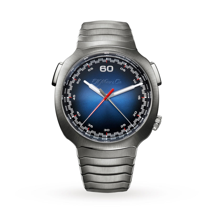 The H. Moser & Cie Streamliner Flyback Chronograph features a stainless steel case, Funky Blue fumé dial, red and white hands, and a metal bracelet, shown front-facing on a white background.