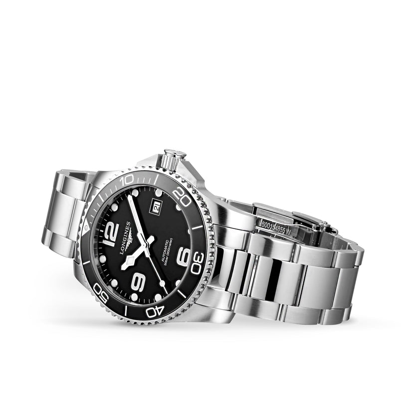 The Longines HydroConquest is a stainless steel diving watch featuring a black dial, white markers, date display, and a metal bracelet, shown against a white background.