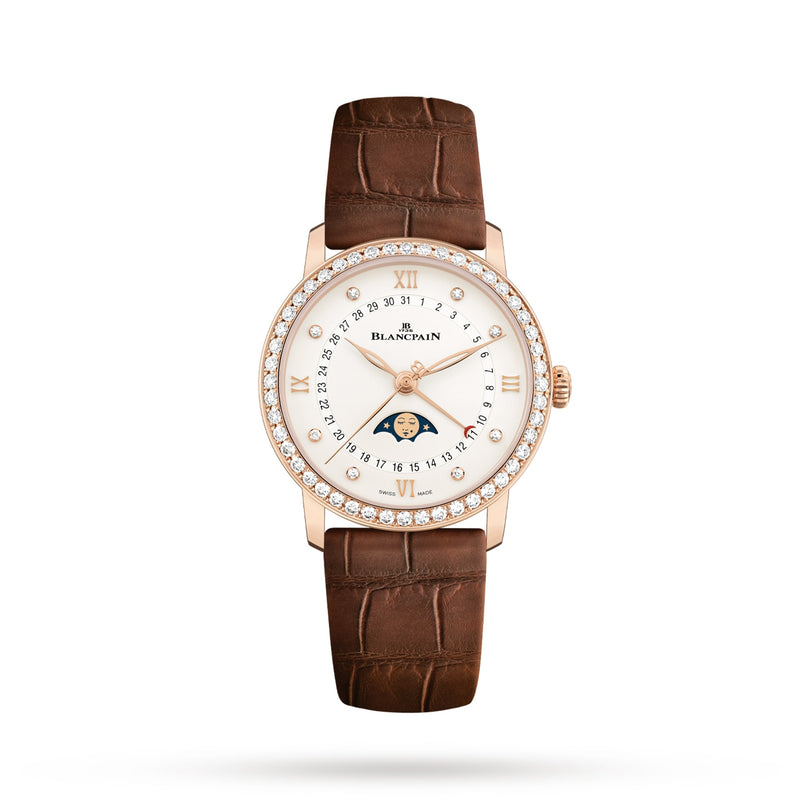 The Blancpain Villeret Quantième Phases de Lune is a luxury watch with a brown leather strap, round 18K red gold diamond-set case, Roman numerals, date display, and an elegant moon phase on the dial.