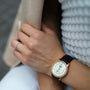 Wearing a Blancpain Villeret Quantième Phases de Lune with a diamond-encrusted case, cream dial, moon phase display, and leather strap, paired with a simple silver ring, resting on textured white fabric.