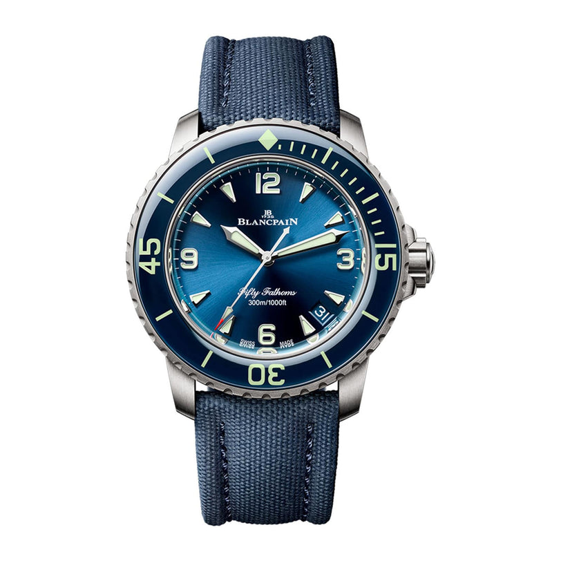 The Blancpain Fifty Fathoms Automatique wristwatch features a blue dial, luminous markers, rotating bezel, and a blue textured strap, displaying the time at 10:10.