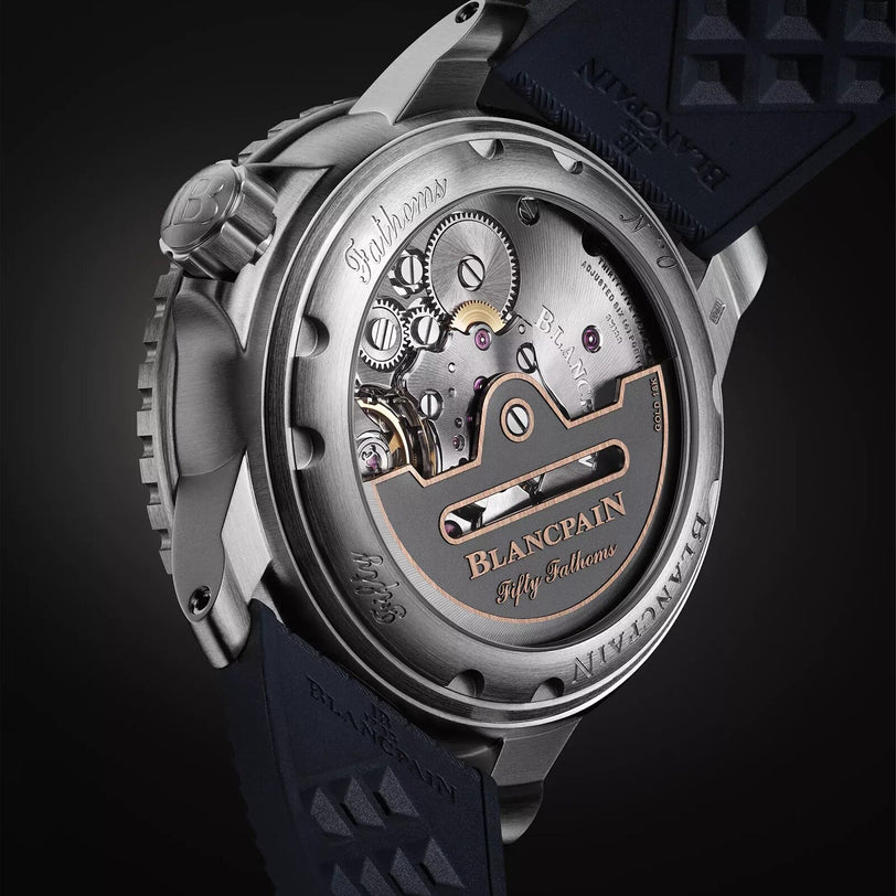 Close-up of the intricate movement on the back of the Blancpain Fifty Fathoms Automatique luxury wristwatch.