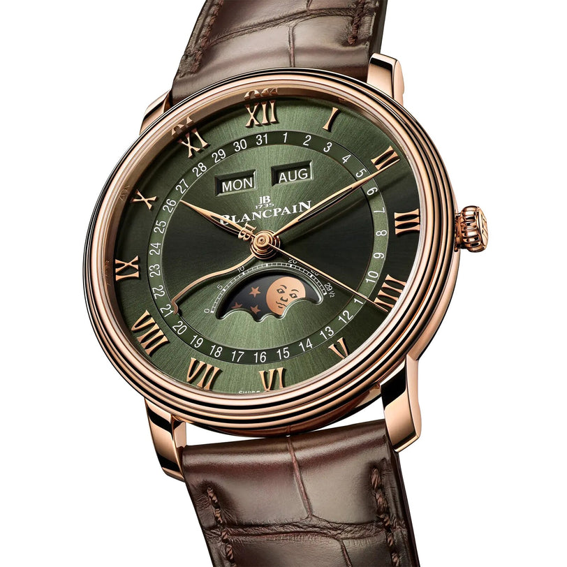 The Blancpain Villeret Quantième Complet is a luxury wristwatch featuring a green dial, gold Roman numerals, day and month windows, moon phase display, and a brown leather strap.