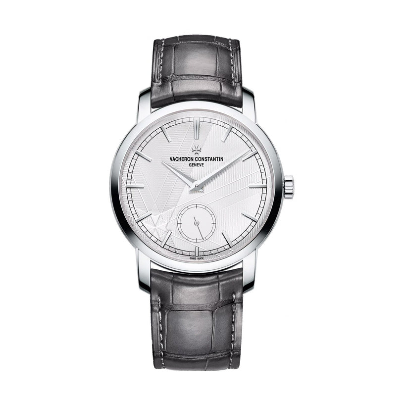 The Vacheron Constantin Traditionnelle Manual-Winding is a platinum wristwatch featuring a white dial, black hour markers, small seconds subdial, and a black leather strap.