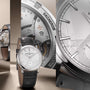 The Vacheron Constantin Traditionnelle Manual-Winding is a luxury limited edition wristwatch with a platinum case, silver dial, black leather strap, and visible mechanical movement shown in close-up detail.