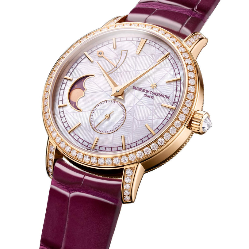 The Vacheron Constantin Traditionnelle Moon Phase features a pink gold case, diamond bezel, silver patterned dial, moon phase display, and a purple leather strap.