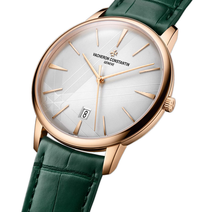 The limited edition Vacheron Constantin Patrimony Self-Winding in 18K pink gold features a white dial, gold hour markers, date display at 6 o’clock, and a green leather strap.