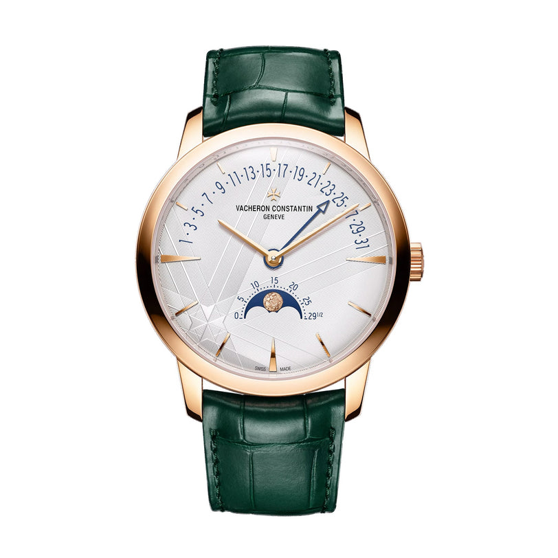 The Vacheron Constantin Patrimony Moon Phase Retrograde Date is a limited edition gold wristwatch with a white dial, green leather strap, retrograde date display, and moon phase on the lower half of the face.