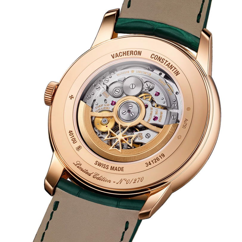 Close-up of the Vacheron Constantin Patrimony Moon Phase Retrograde Date wristwatch, showing its 18K pink gold case, complex mechanical movement, and engraved Limited Edition and serial number details on the back.