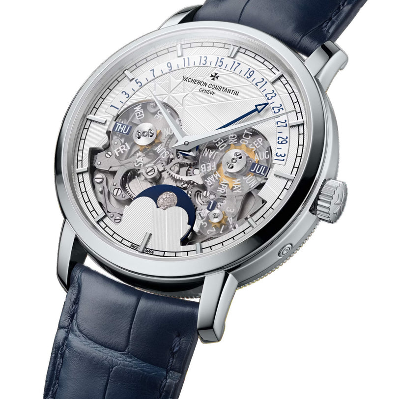 The Vacheron Constantin Traditionnelle Perpetual Calendar Retrograde Date Openface is a platinum wristwatch with a blue leather strap, openworked dial, self-winding movement, and features perpetual calendar and moon phase indicators.