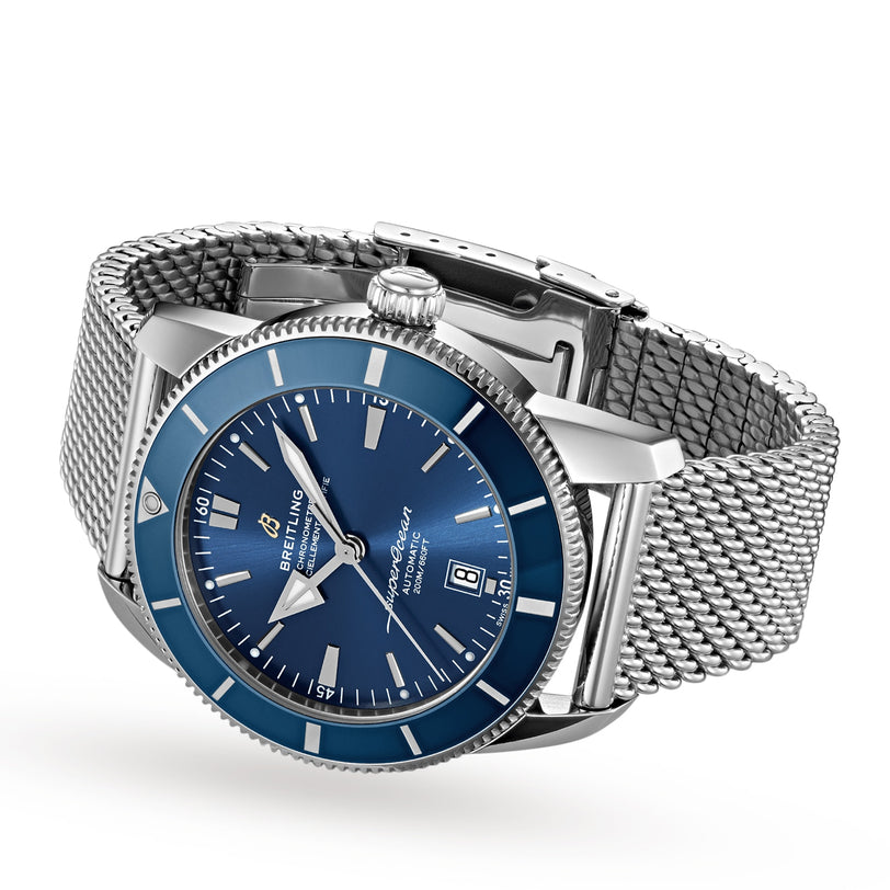 A Breitling Superocean Heritage B20 Automatic 46 wristwatch with a blue dial, date display, and mesh metal strap is shown on a white background, featuring water resistance and powered by the Breitling B20 calibre.