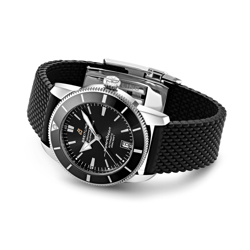 The Breitling Superocean Heritage B20 Automatic 42 features a stainless steel case, silver bezel, black dial with date display, and a textured black rubber strap; shown angled on a white background.