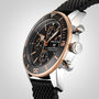 A close-up of the Breitling Superocean Heritage B20 Automatic 44 with a black dial, ceramic bezel, rose gold accents, and a black textured strap.